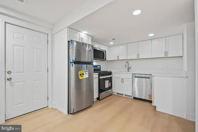 a close view of a utility room with dryer and washer