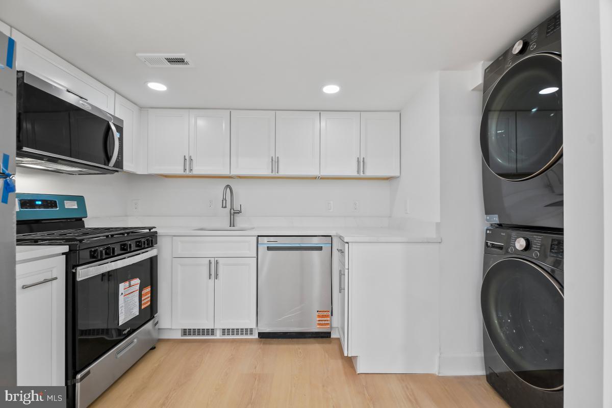 8728 # Courthouse Road Vienna, VA 22182 - Photo 13 of 34 a kitchen with stainless steel appliances granite countertop a stove a sink and a microwave