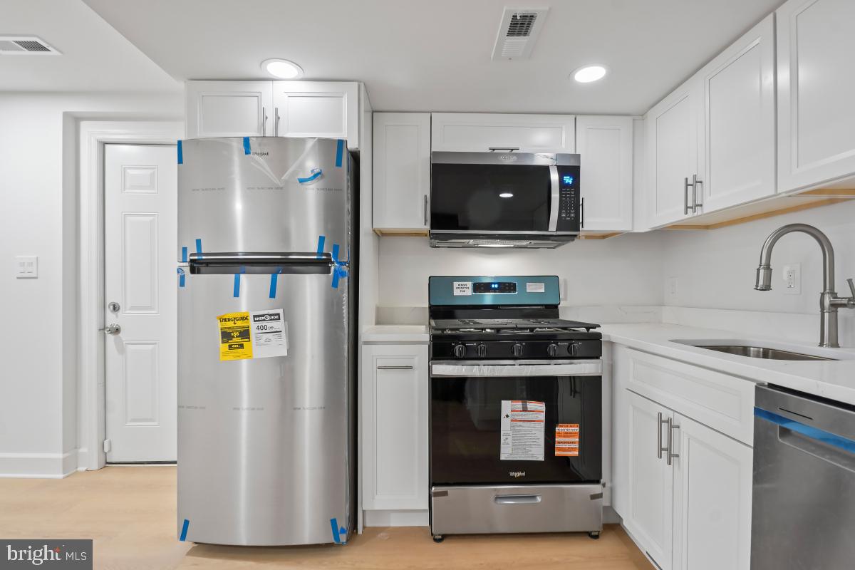 8728 # Courthouse Road Vienna, VA 22182 - Photo 14 of 34 a kitchen with a refrigerator and a sink