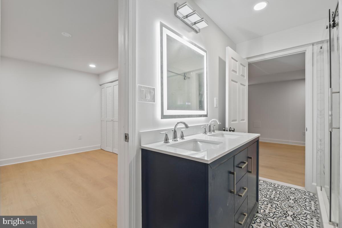 8728 # Courthouse Road Vienna, VA 22182 - Photo 23 of 34 a bathroom with a sink and a mirror