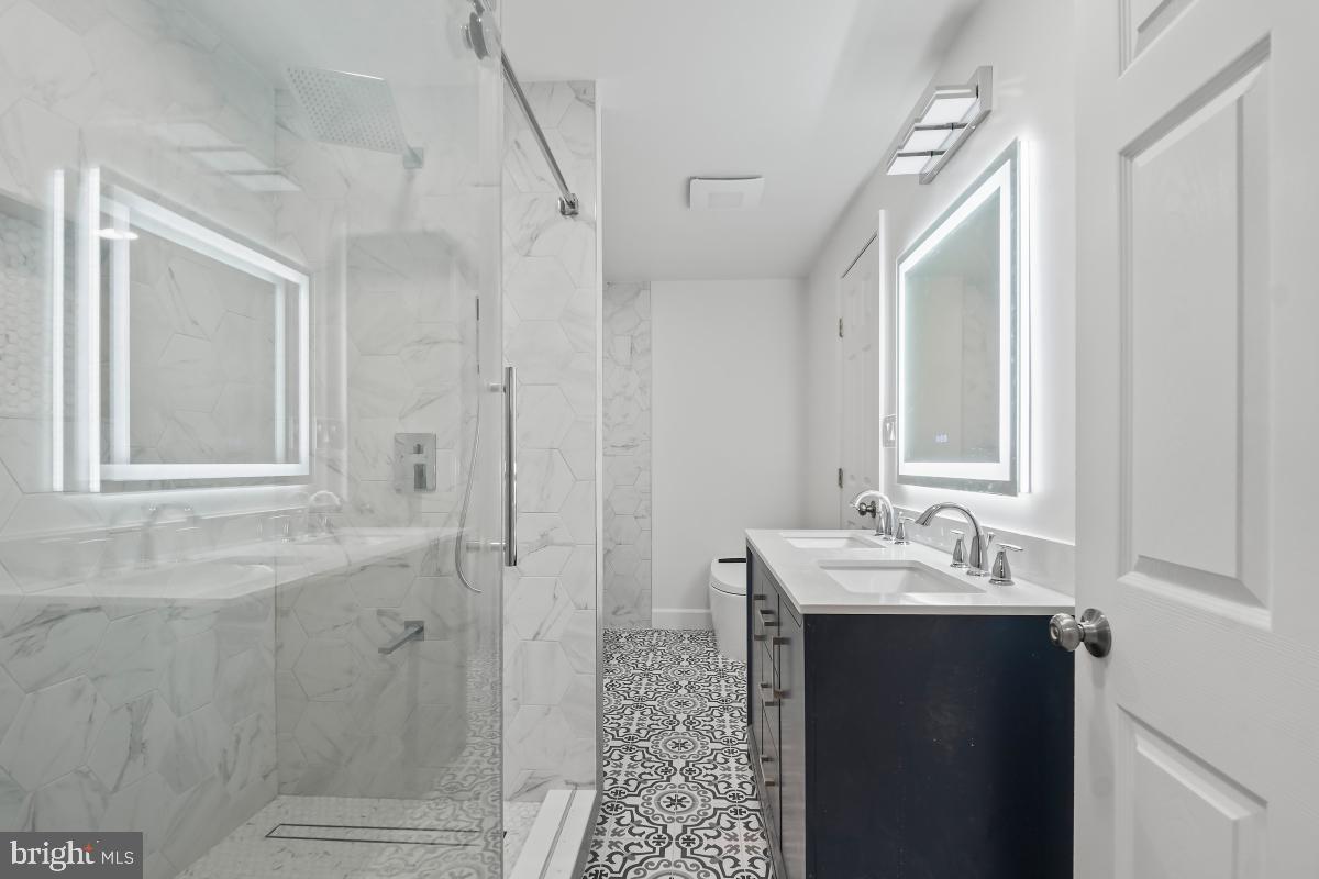 8728 # Courthouse Road Vienna, VA 22182 - Photo 25 of 34 a bathroom with a sink and mirror with shower