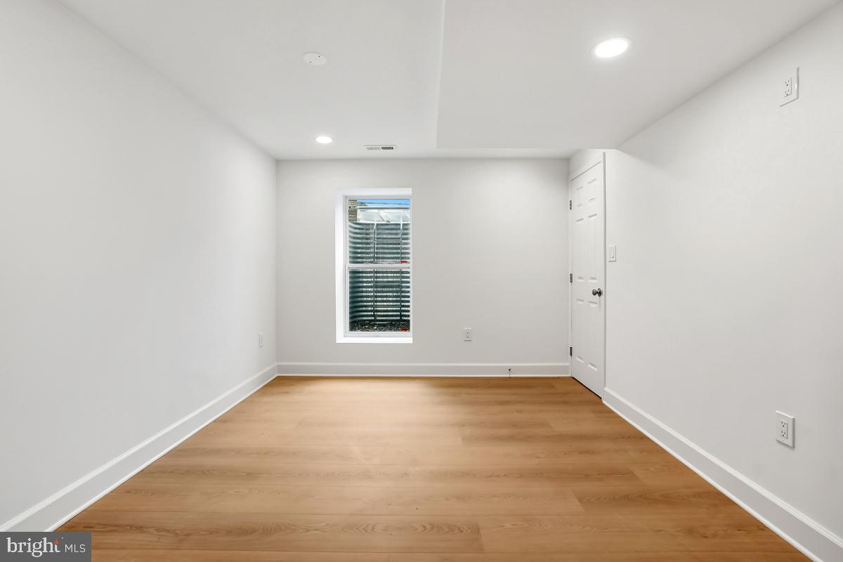 8728 # Courthouse Road Vienna, VA 22182 - Photo 27 of 34 an empty room with wooden floor and windows
