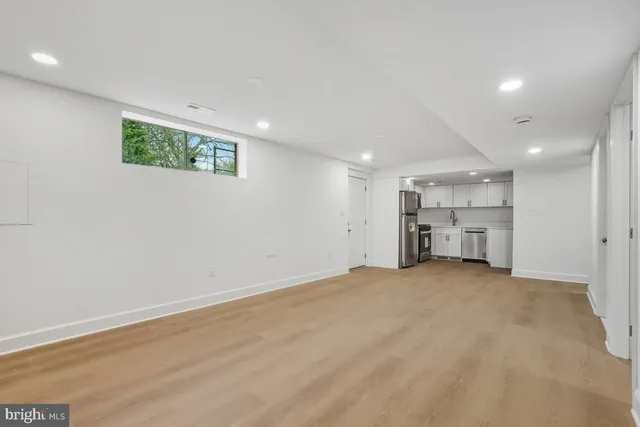 a view of a kitchen with a sink and white cabinets