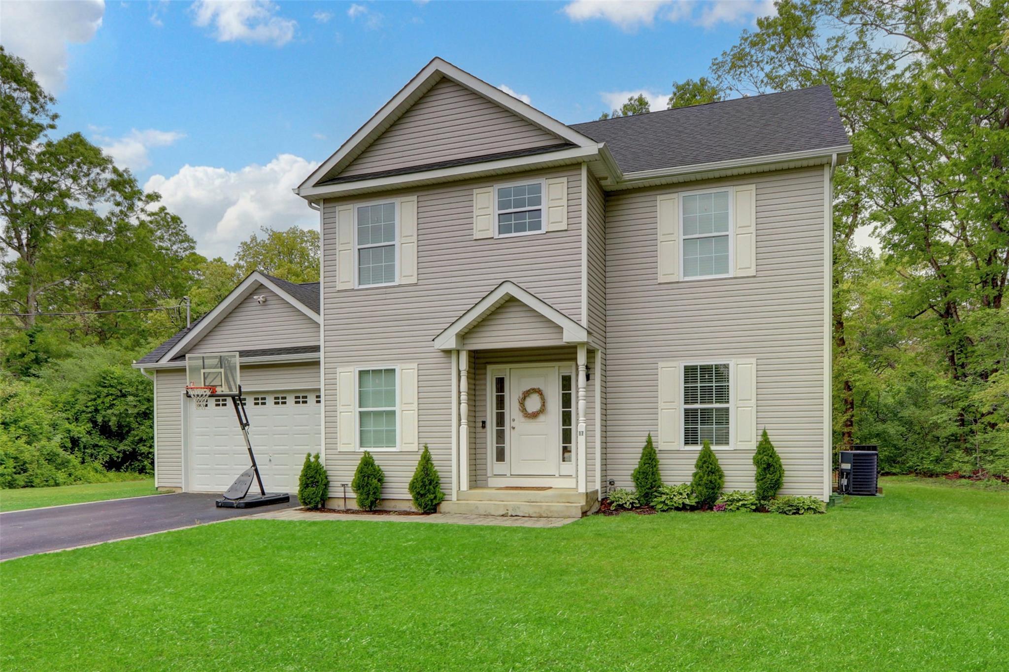 17 Conservation Circle Ridge, NY 11961 - Photo 1 of 1 a front view of a house with a garden