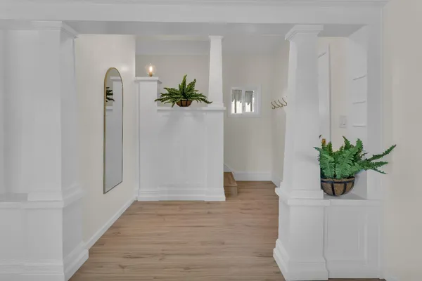 a view of an entryway with wooden floor