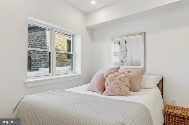 a bedroom with a bed and a window