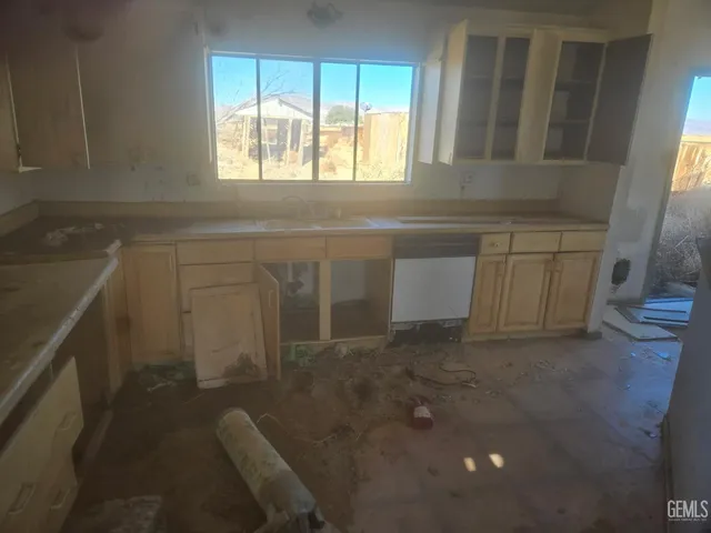 a kitchen with a sink and cabinets