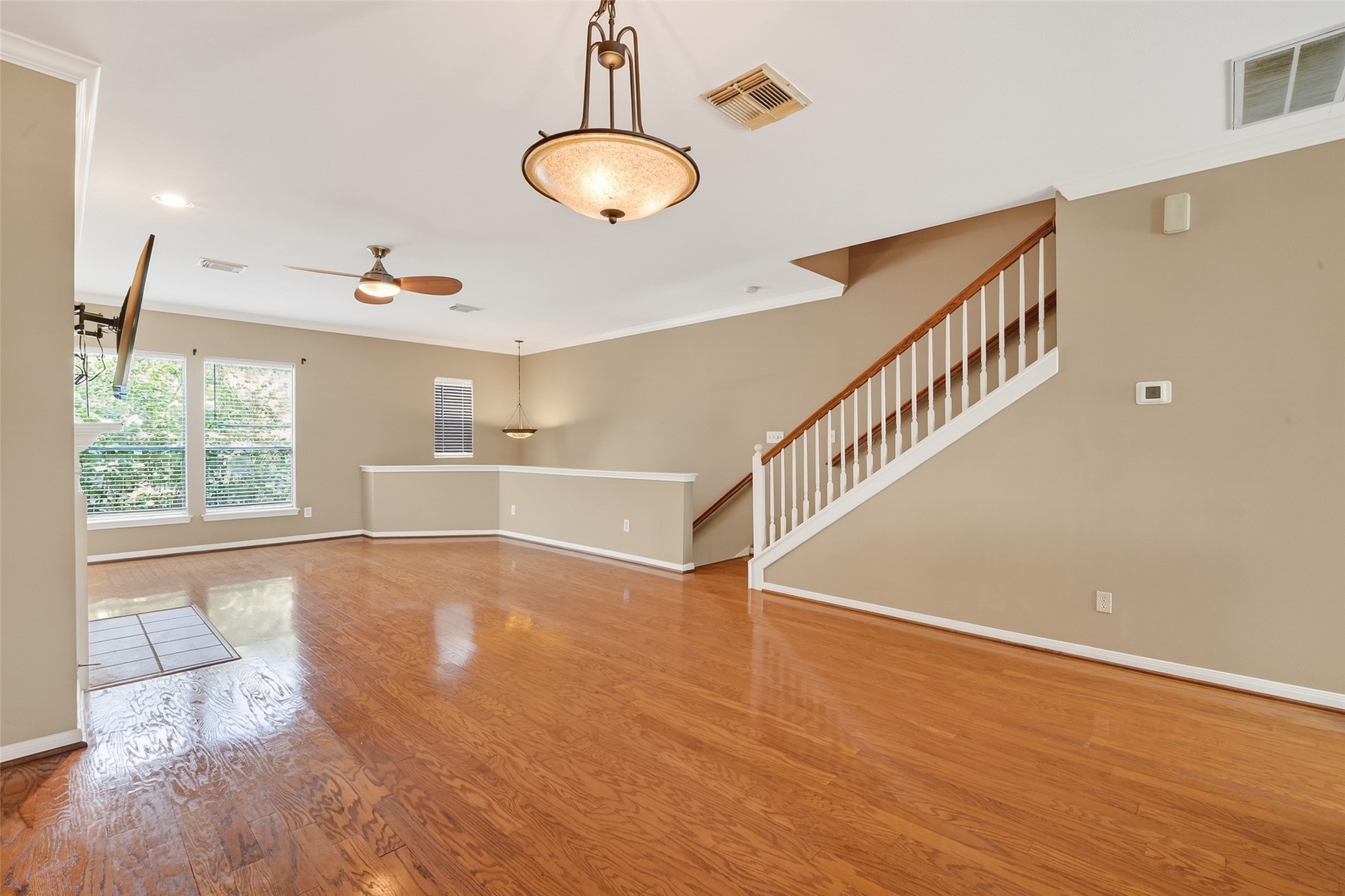 2804 Chenevert Street Houston, TX 77004 - Photo 10 of 37 a view of an empty room with wooden floor and windows