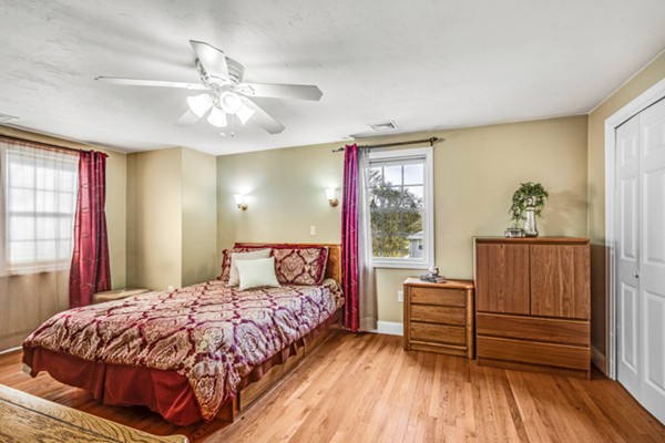 15 Lillian Road Lexington, MA 02420 - Photo 18 of 30 a spacious bedroom with a bed and wooden floor
