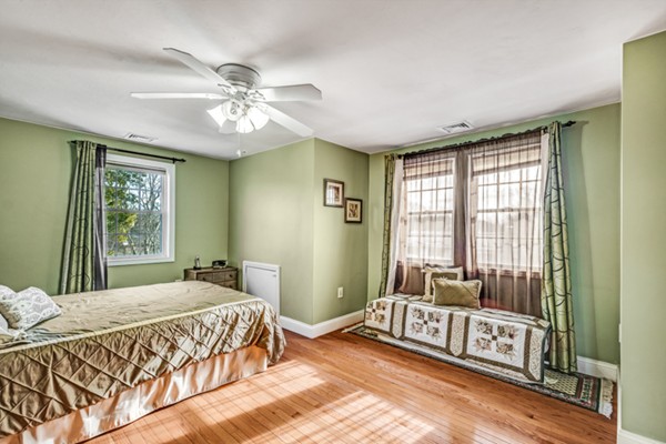 15 Lillian Road Lexington, MA 02420 - Photo 21 of 30 a spacious bedroom with a bed and a chandelier