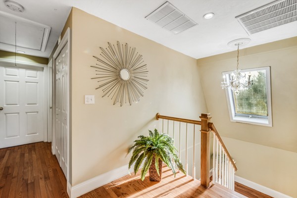 15 Lillian Road Lexington, MA 02420 - Photo 24 of 30 a view of hallway with wooden floor and chandelier