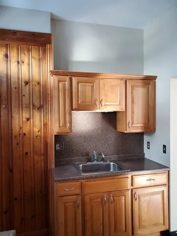 a kitchen with granite countertop a sink a window and stainless steel appliances