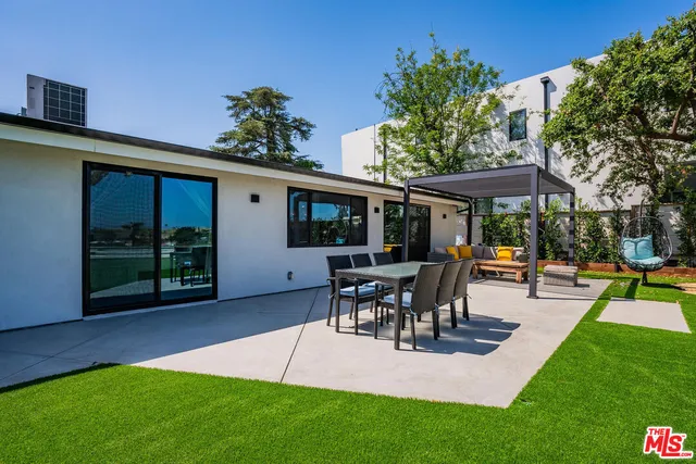 a view of yard with swimming pool and green space