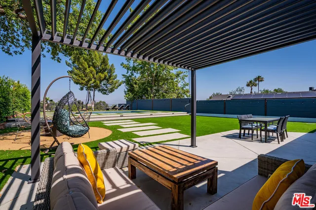 a view of a house with backyard porch and sitting area