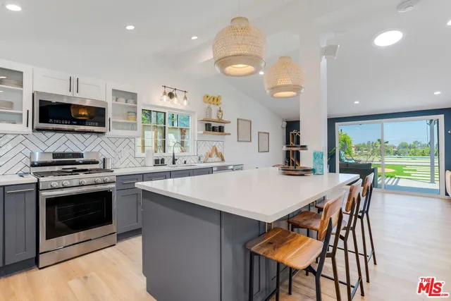 a kitchen with lots of counter top space and furniture