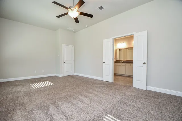 a view of an empty room and kitchen view