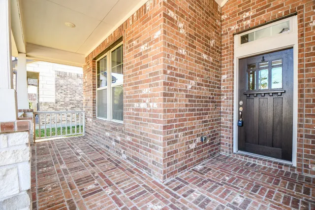 a view of a brick house with many windows