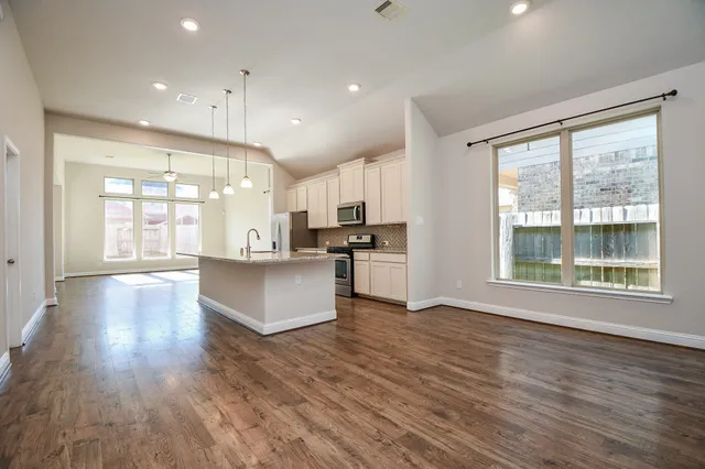 a view of kitchen with cabinets and wooden floor