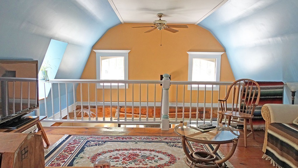 172 Braley Hill Road Rochester, MA 02770 - Photo 19 of 28 a living room with furniture and a floor to ceiling window