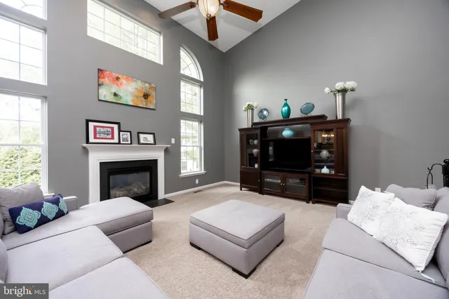 a living room with furniture a chandelier and a fireplace