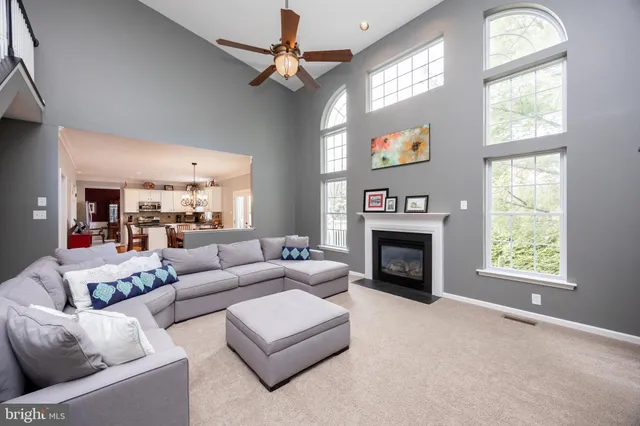 a living room with furniture or stairs and a ceiling fan