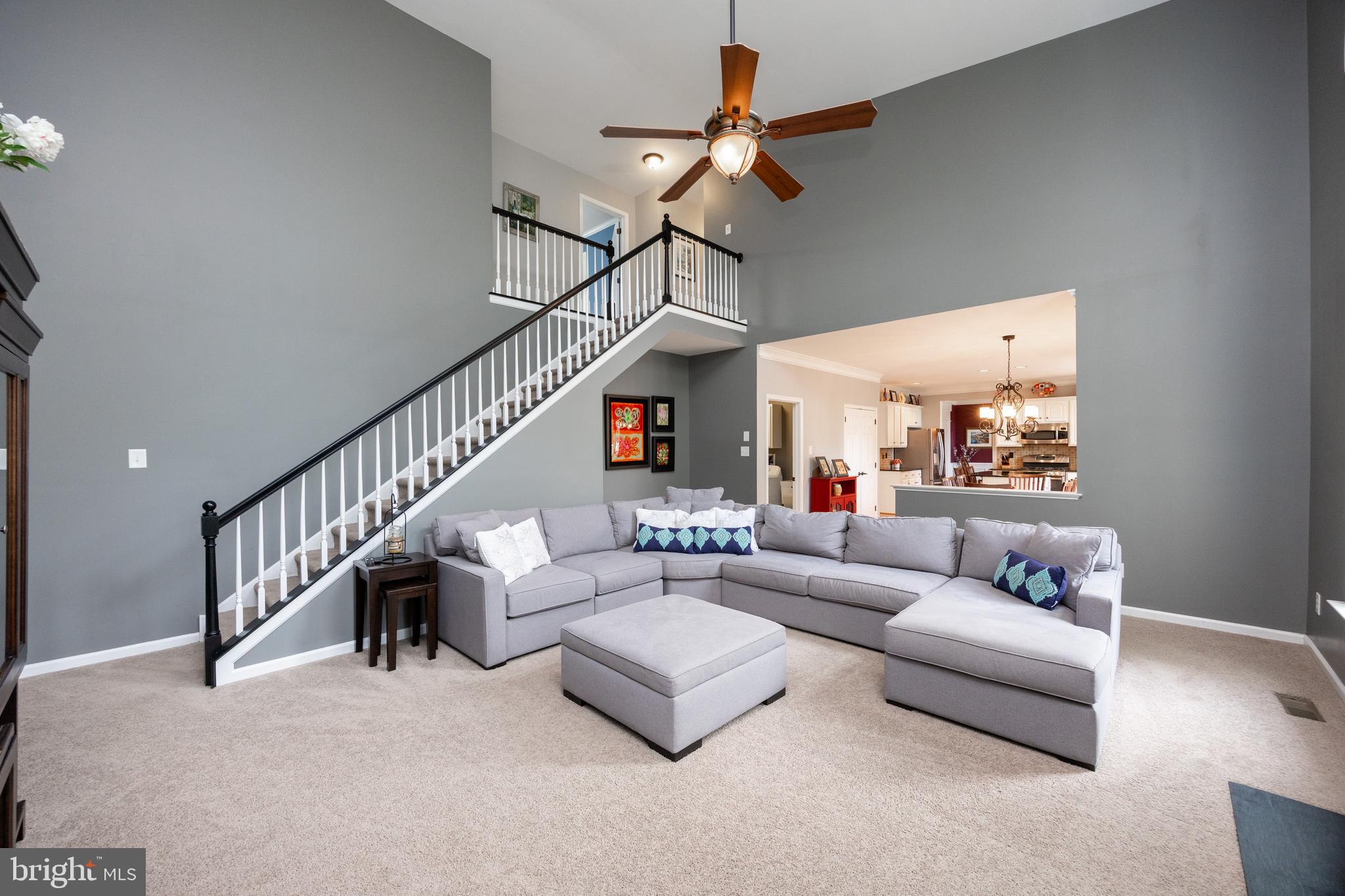 113 Blue Ribbon Way Downingtown, PA 19335 - Photo 18 of 50 a living room with furniture or stairs and a ceiling fan