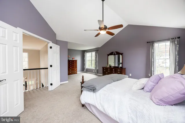 a spacious bedroom with a bed and a chandelier