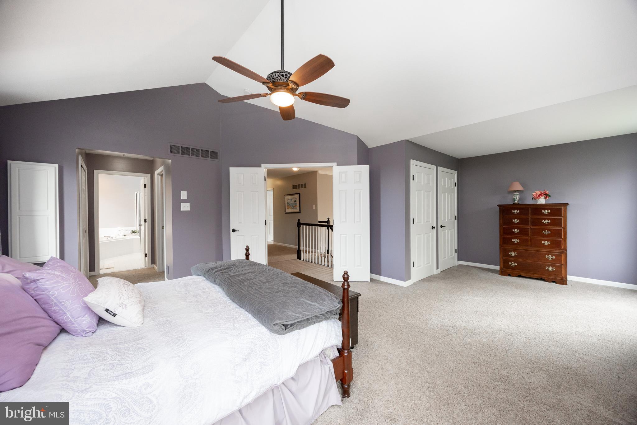 113 Blue Ribbon Way Downingtown, PA 19335 - Photo 23 of 50 a spacious bedroom with a bed and a chandelier