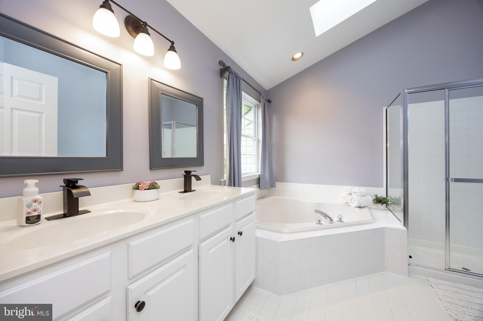 113 Blue Ribbon Way Downingtown, PA 19335 - Photo 25 of 50 a bathroom with a bathtub a mirror a double vanity sinks and vanity