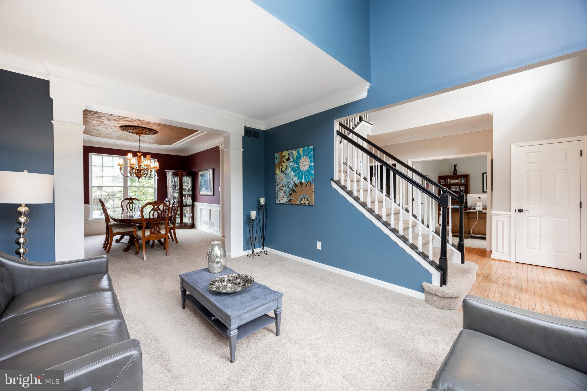 113 Blue Ribbon Way Downingtown, PA 19335 - Photo 3 of 50 a living room with furniture and a dining table with projector the view