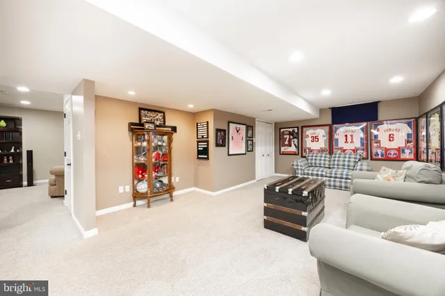 a living room with furniture and wall paintings