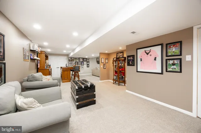 a living room with furniture a piano and a bookshelf