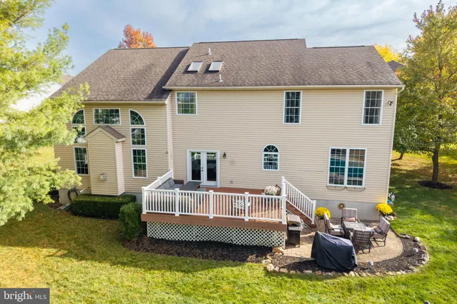 an aerial view of a house with garden space and trees