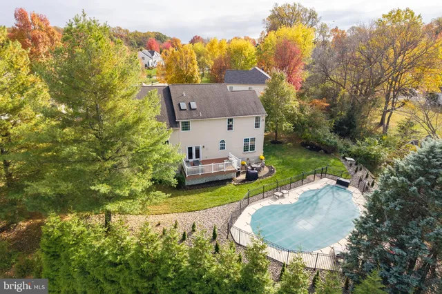 an aerial view of a house with a garden and swimming pool
