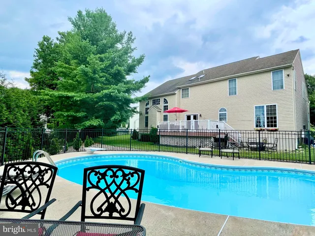 a green field with trees in the background