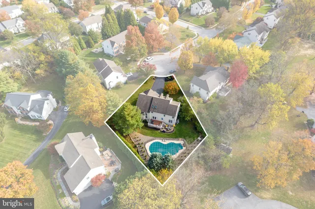 an aerial view of residential houses with city view