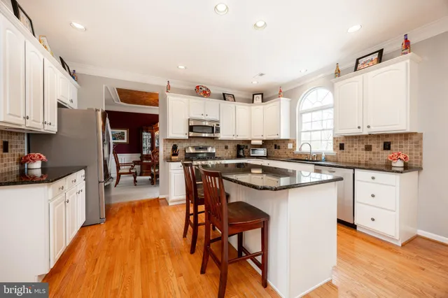 a kitchen with stainless steel appliances a refrigerator sink and cabinets