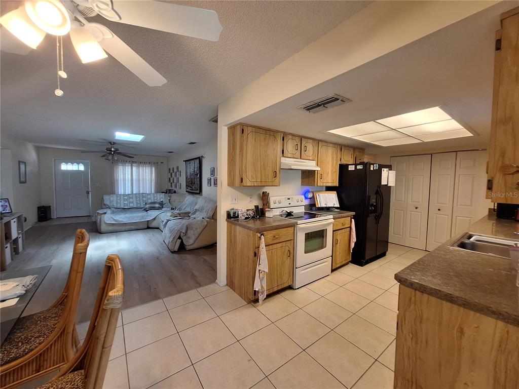 419 Falcon Avenue Edgewater, FL 32141 - Photo 2 of 8 a kitchen with stainless steel appliances granite countertop a sink counter space and cabinets