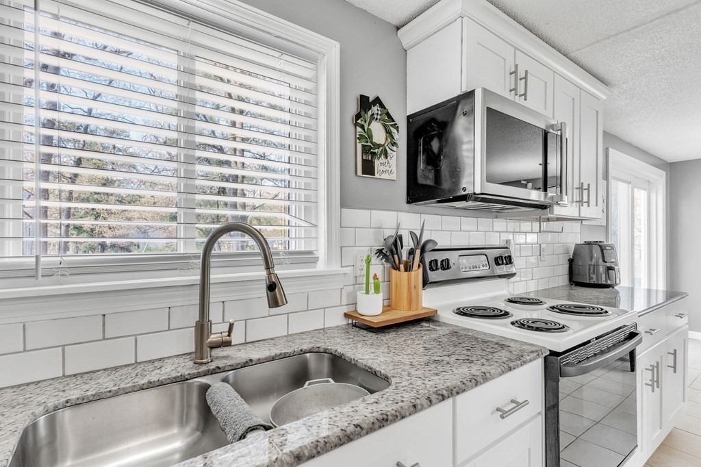 242 Gilbert Avenue Springfield, MA 01119 - Photo 18 of 38 a kitchen with a sink and a stove top oven