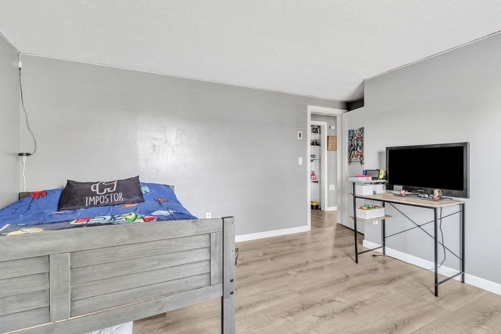 242 Gilbert Avenue Springfield, MA 01119 - Photo 25 of 38 a bedroom with a bed and a flat screen tv