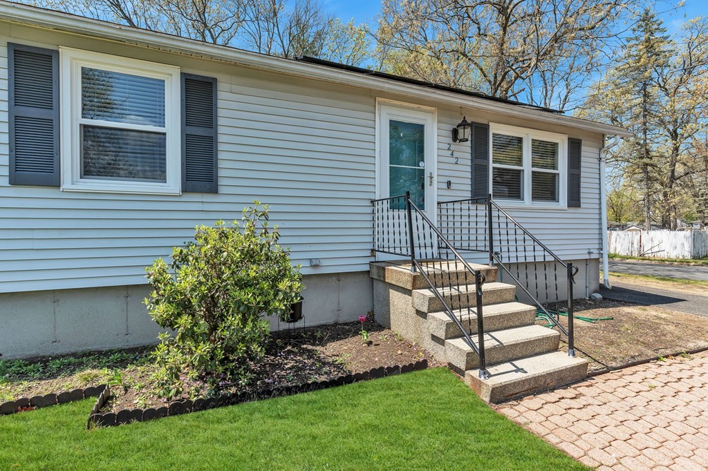 242 Gilbert Avenue Springfield, MA 01119 - Photo 6 of 38 a front view of a house with garden