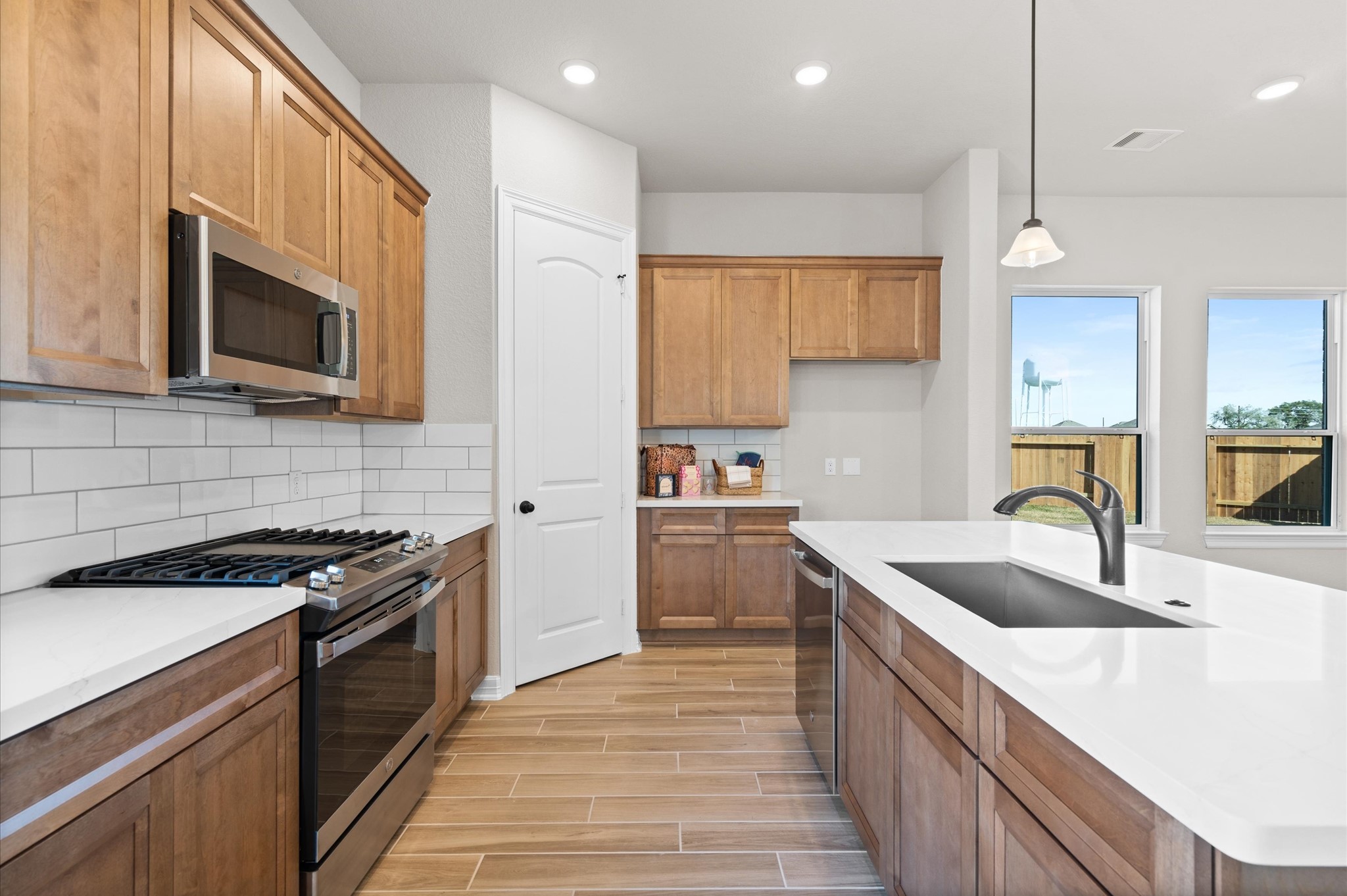 1225 Friendship Trail Seabrook, TX 77586 - Photo 9 of 22 a kitchen with stainless steel appliances granite countertop a sink stove and microwave