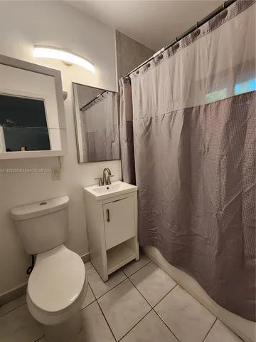 a bathroom with a toilet sink and shower