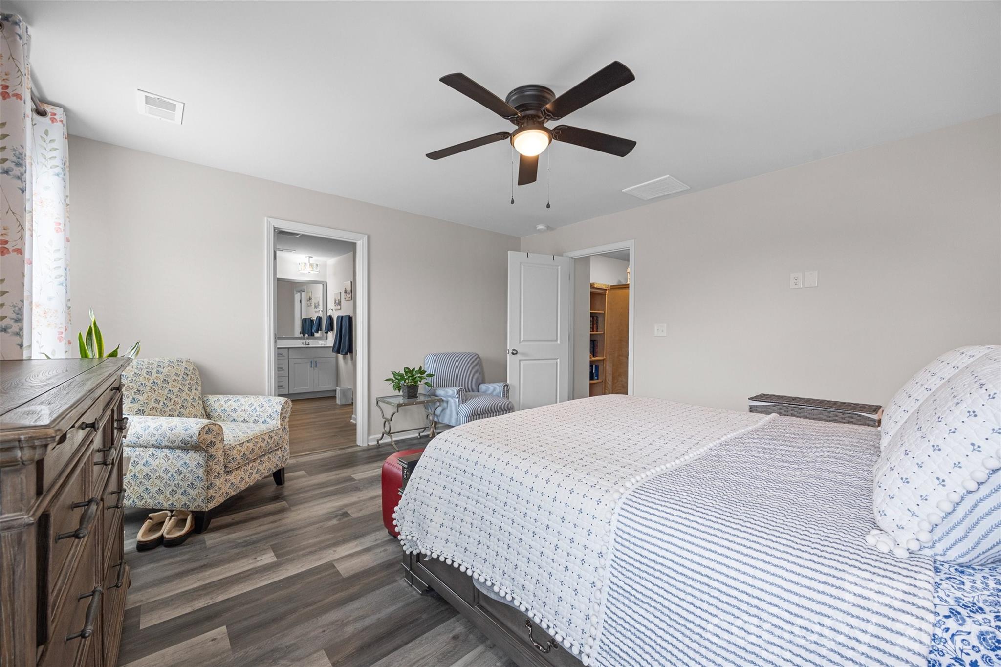 359 Olympia Way York, SC 29745 - Photo 22 of 27 a bedroom with a large bed and a chandelier