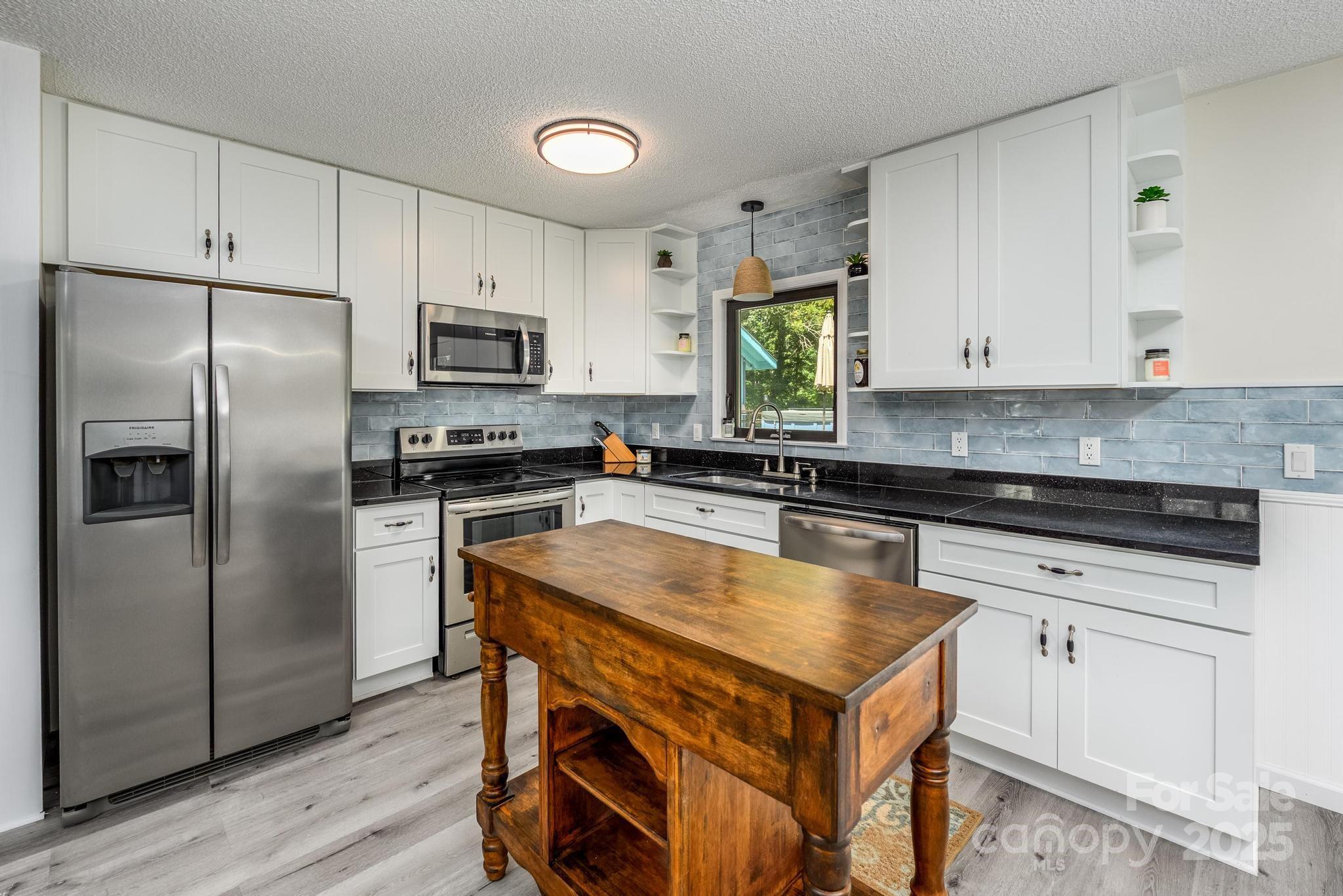 160 Clairmont Road Salisbury, NC 28146 - Photo 13 of 42 a kitchen with a stove a refrigerator and a sink