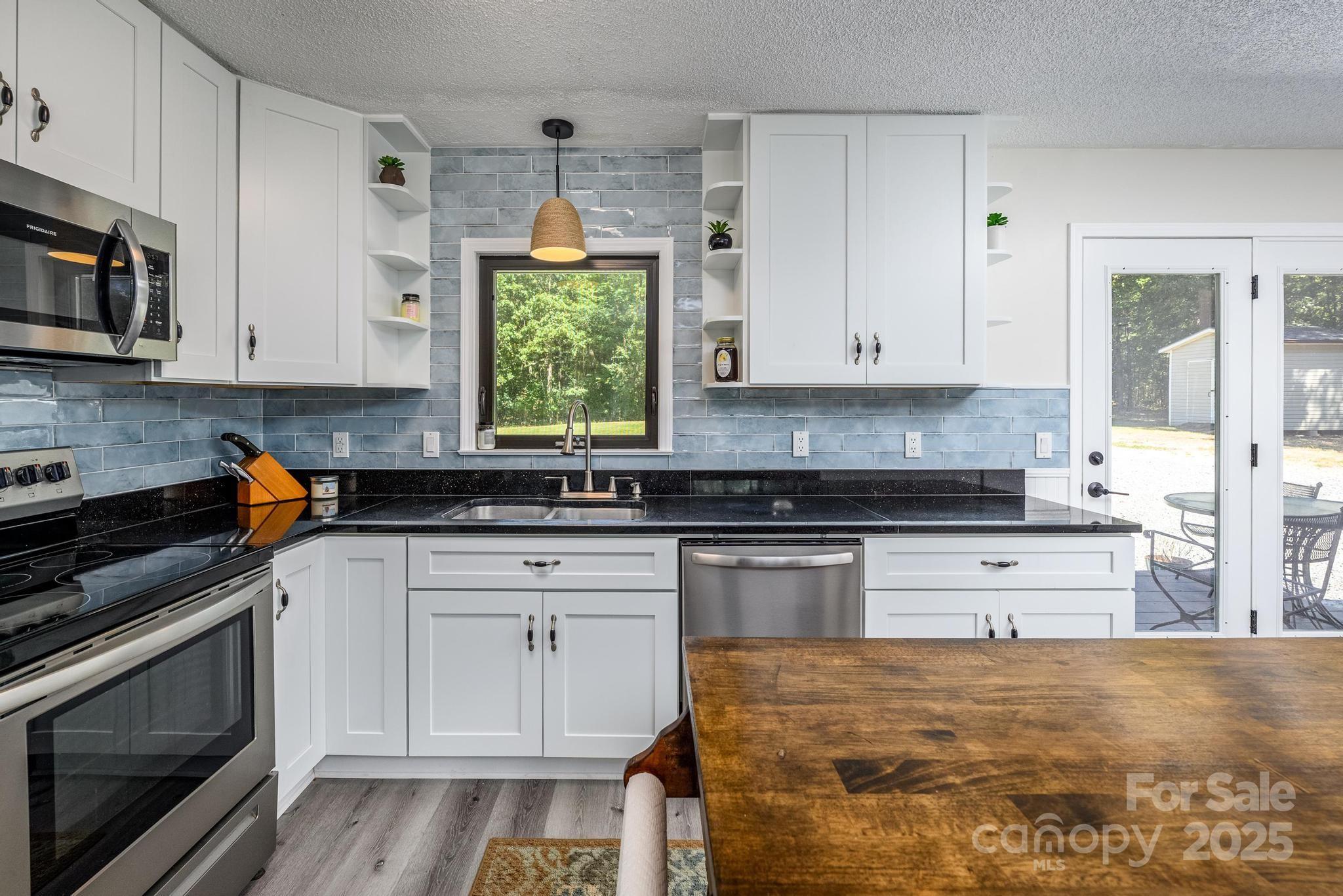 160 Clairmont Road Salisbury, NC 28146 - Photo 14 of 42 a kitchen with stainless steel appliances granite countertop a stove a sink and a microwave