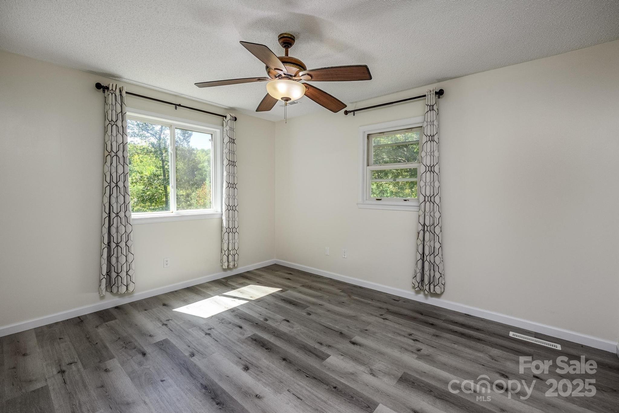 160 Clairmont Road Salisbury, NC 28146 - Photo 18 of 42 a view of empty room with wooden floor and fan