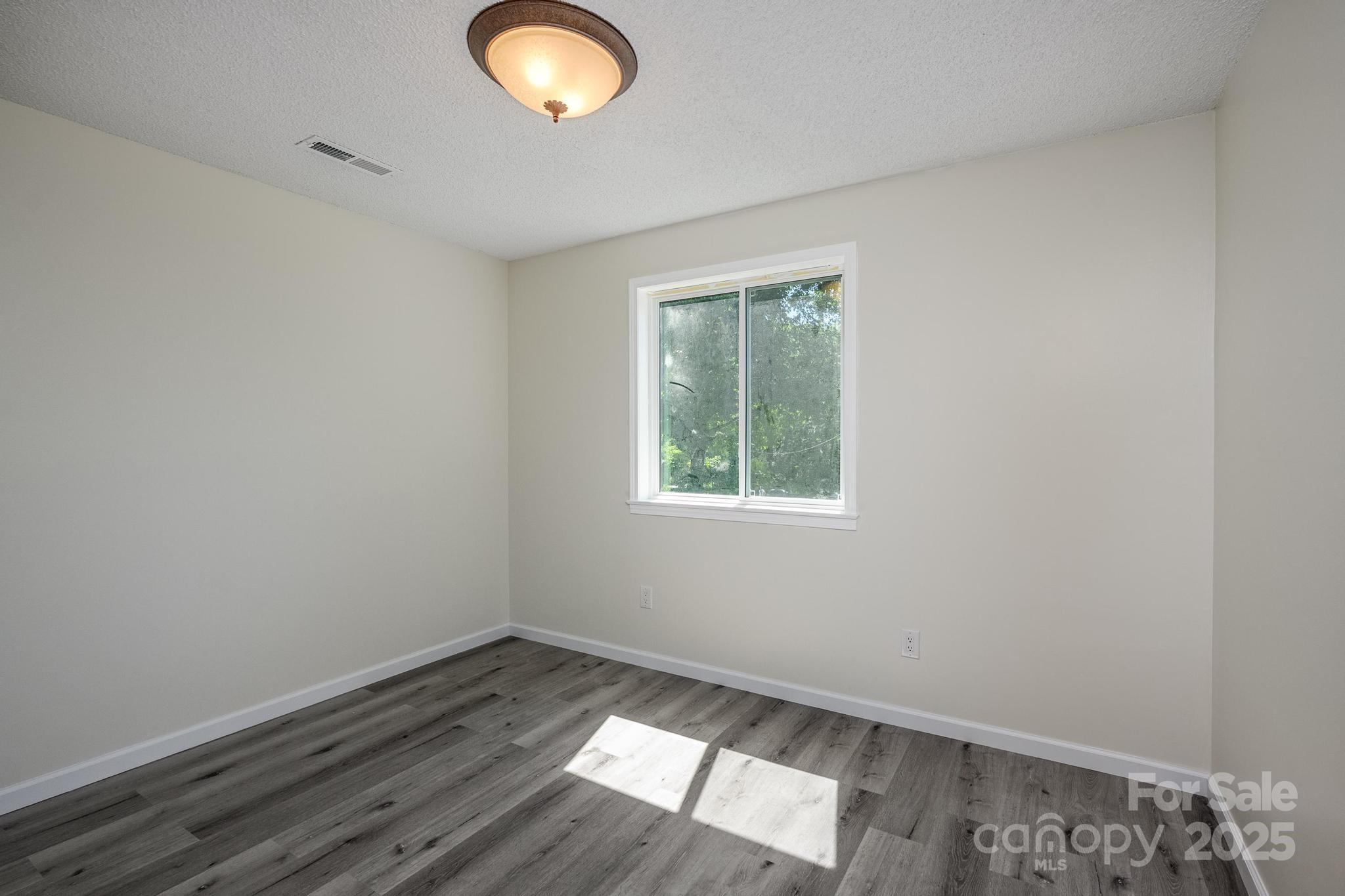 160 Clairmont Road Salisbury, NC 28146 - Photo 21 of 42 an empty room with wooden floor and windows