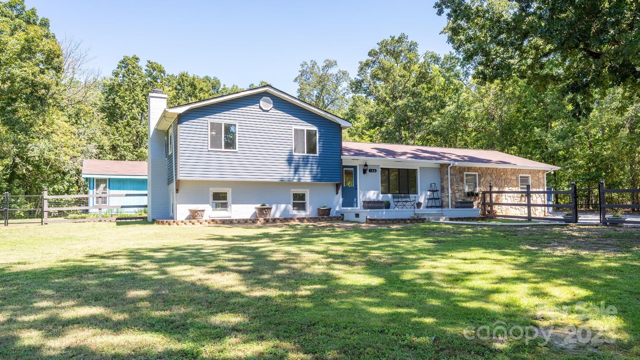 160 Clairmont Road Salisbury, NC 28146 - Photo 3 of 42 a front view of a house with a garden and trees