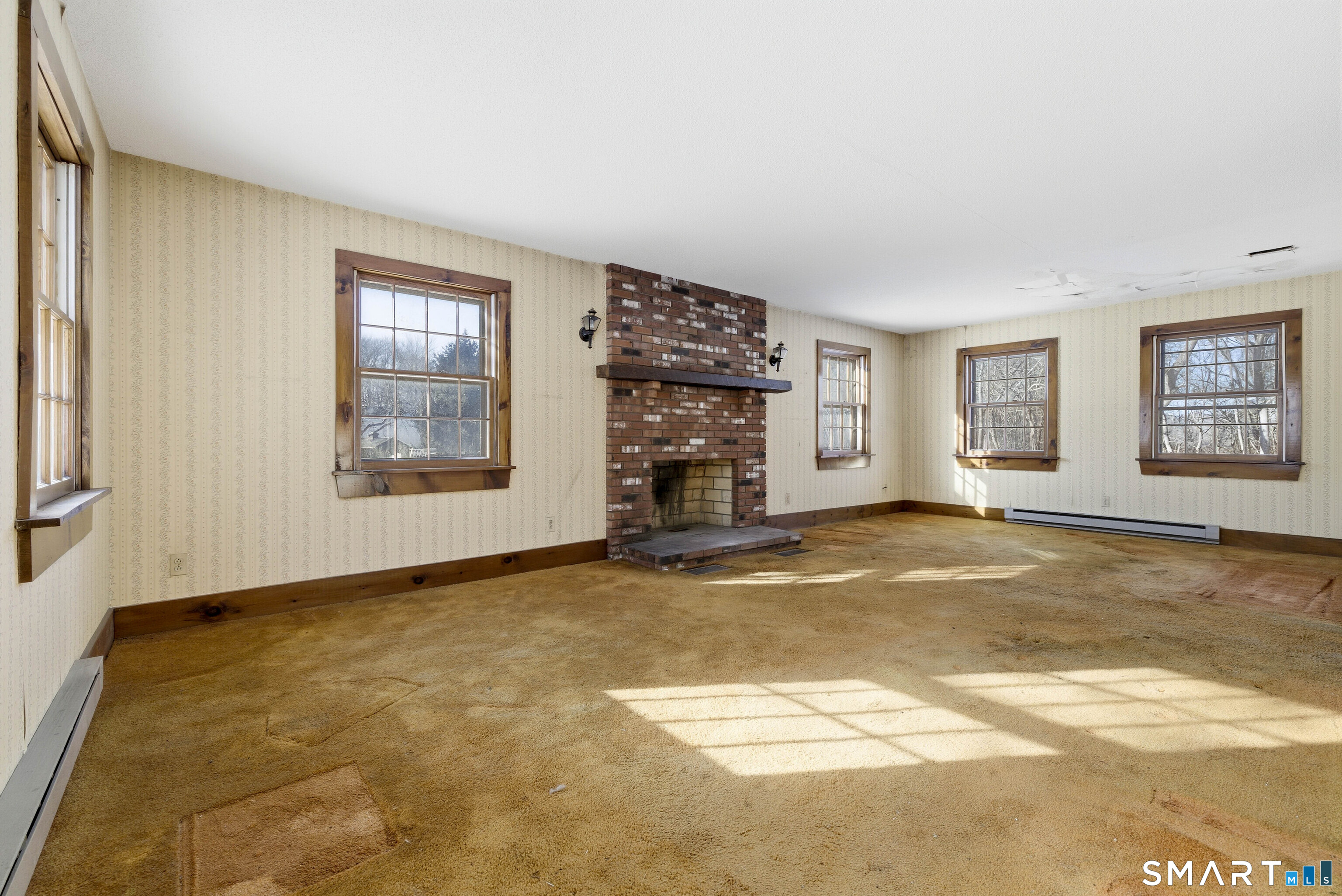 115 Melrose Road East Windsor, CT 06016 - Photo 12 of 28 an empty room with a fireplace and painted walls